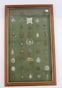 Framed collection of 45 British military cap badges