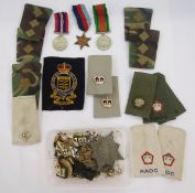 WWII Defence Medal, War Medal and 1939-45 Star, together with military badges and rank markings