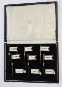 Cased set of Art Deco silver sandwich markers, comprising six hallmarked silver flags and a quantity