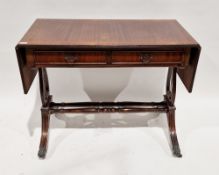 Mahogany-effect sofa table in the Regency manner with drop-flaps to either end, two frieze drawers