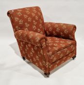 Early 20th century armchair with floral patterned upholstery on a brown ground, on oak bun feet with