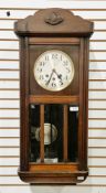 Early 20th century mahogany and oak cased hanging wall clock, the circular silver dial with three