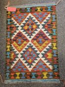 Maimana Kilim cream ground rug with central lozenge and geometric pattern flanked by single