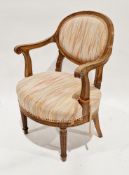 French oak elbow chair in the Louis XVI manner with an upholstered oval back and seat, scrolling