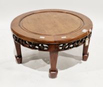 Chinese hardwood circular coffee table with a pierced carved frieze depicting birds and flowers,