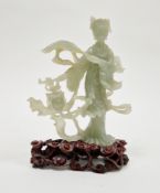 20th century Chinese carved green stone model of a Guanyin, she standing holding a whisk amongst