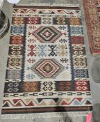 Cream ground kilim with two lozenge medallions on geometric field, single geometric border flanked