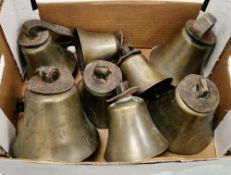 Collection of eight 19th century brass handbells of various sizes, two with leather hand straps in
