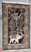 Persian-style midnight ground rug, the central field with elephant and peacocks in tree, multiple