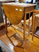 Edwardian mahogany and satinwood inlaid side table in the Sheraton manner, the drop-flap oval swivel