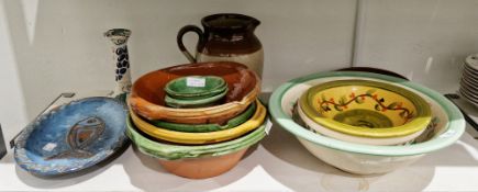 Collection of utilitarian kitchen pottery including a group of French-style glazed terracotta