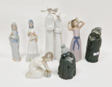 Group of Lladro figures, including a figure group of two nuns, 32.3cm high, two figures of girls