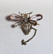 Yellow metal brooch in the form of a butterfly, the wings set with pink and blue faceted stones,