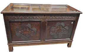 Antique oak coffer, the two panel hinged lid over a frieze carved with fleur-de-lys and initialled