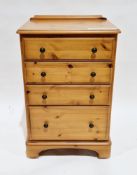 Modern pine chest of four graduated drawers with metal knob handles, on castors, 89cm high x 57cm