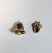 Two 9ct gold charms, one in the form of a bell (1.2cm high), the other an acorn, 3.1g approx.