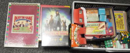 Two boxes of puzzles and games to include Pandemic, Settlers of Catan, Carcassonne, Twist &