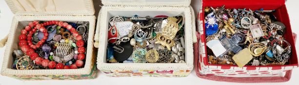Three fabric covered sewing or jewellery boxes full with mixed costume jewellery including rings,