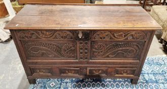 17th/18th century carved oak mule chest, the hinged top with thumbmould edge, the panelled front