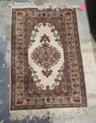 Turkish cream ground wool pile rug with central floral medallion and floral spandrels, with multiple