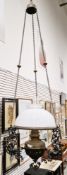 Victorian cast iron and brass hanging oil lamp having an opaque glass domed shade, brass well,