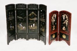 Two Japanese lacquered folding screens, the first being a four-fold screen decorated in gilt and