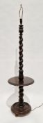 Early 20th century oak standard lamp, the twisted and foliate carved column with an integrated