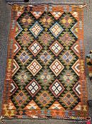 Maimana Kilim black ground rug with two rows of four lozenges and three rows of five hooked