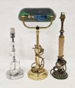 Three table lamps including a banker's style lamp with green glass swivel shade and straight brass
