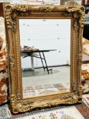 Rococo-style carved giltwood wall mirror rectangular with bevel edged plate and exuberantly