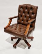 Brown buttoned leather upholstered office elbow swivel chair in the George III manner, 99cm high x
