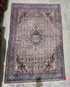 Persian-style cream ground rug with central floral medallion on interwoven floral field, floral