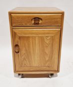 Ercol light elm Windsor bedside cabinet with a single drawer over a single cupboard door, on