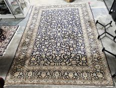 Iranian blue ground carpet with central floral motif on floral field, single herati border and