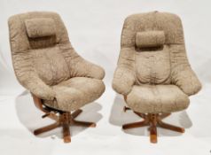 Pair of Ekornes style stressless swivel armchairs having flower pattern brown fabric upholstery