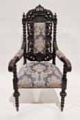 19th century oak hall elbow chair profusely carved including a crown and cherub domed top rail,