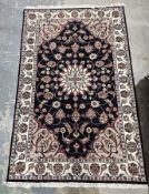 Persian-style midnight ground rug with central floral medallion on floral field with floral