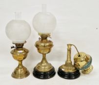 Two late 19th / early 20th century brass oil lamps, each with white opaque etched glass bulbous