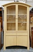 Modern rattan display cabinet by Trumps of Guildford, 'Bella' range with domed top and two glazed