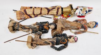 Three south-east Asian painted wooden puppets in traditional dress on block bases, 38cm high