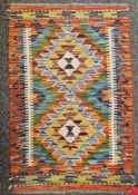 Chobi Kilim orange ground rug with two central lozenge medallions flanked by single geometric border