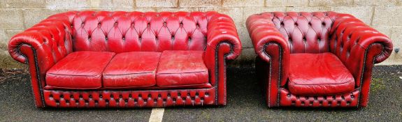 Office reception Chesterfield-style red buttoned leather-effect three-seater sofa with brass