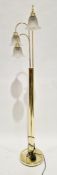 Modern gilt-effect standard lamp with three arched branches, with glass opaque shades, on circular