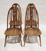Set of four Ercol Windsor Range hoop and spindle back elm seated dining chairs with swan motifs,