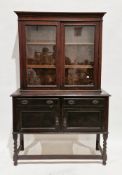 Early 20th century oak dresser, the upper section with two glazed doors enclosing two adjustable