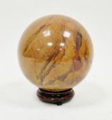 Large polished agate jasper ball, approximately 16cm diameter on wooden stand