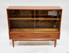 Mid-century retro teak cabinet by Jentique, having two glass sliding doors opening to an