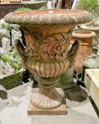 Terracotta garden urn of classical campana form with moulded flora and foliate scroll decoration,