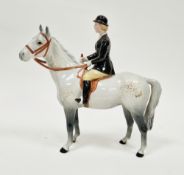 Beswick pottery model of an equestrian huntswoman, she on a dappled grey/white horse wearing a black