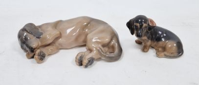 Two 20th century Royal Copenhagen models of dachshunds, printed green and blue factory marks,